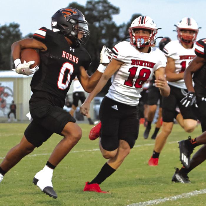 Schulenburg’s Byron Johnson speeds away from a Burton’s Ryder Biggs during Friday’s game. Photo by Darrell D. Gest