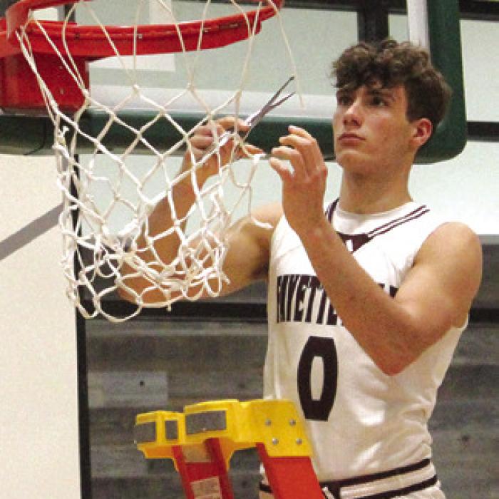 In a thrilling state semifinal victory over Huckabay Monday, the Fayetteville Lions boys basketball team punched their ticket to Thursday’s state title game. After the game all the Lions took turns cutting down a piece of the net, symbolizing that they are the last 1A team standing from Regions III and IV. Here’s Enoch Loafman cutting his piece. More on the historic win on page B1 today. Photo by Jeff Wick