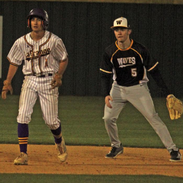 La Grange’s Ty Stark, left, leads off second in Tuesday’s win.