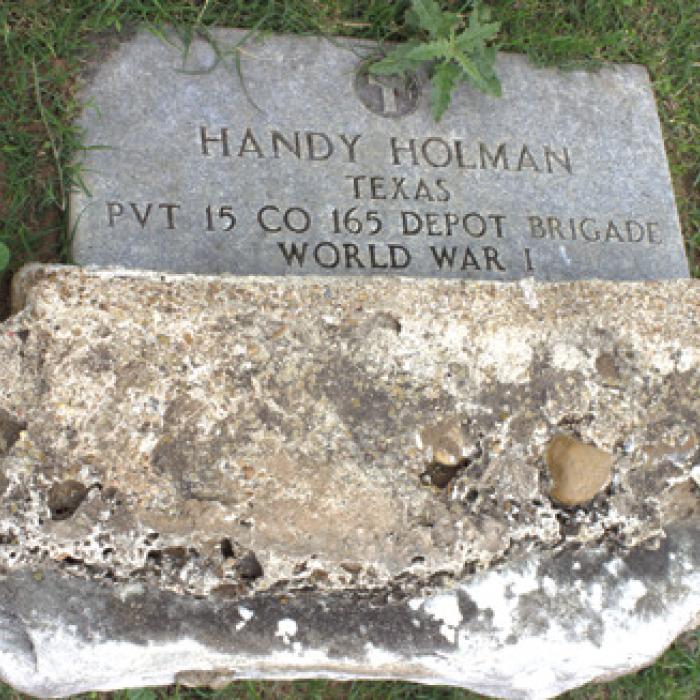 Handy Holman turned over headstone. Photo courtesy of the Hills.