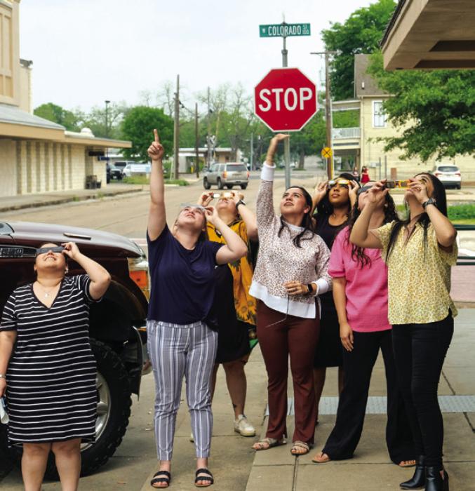 NBT bank employees ventured out of their offices to check out the eclipse in downtown La Grange. Photo by Andy Behlen