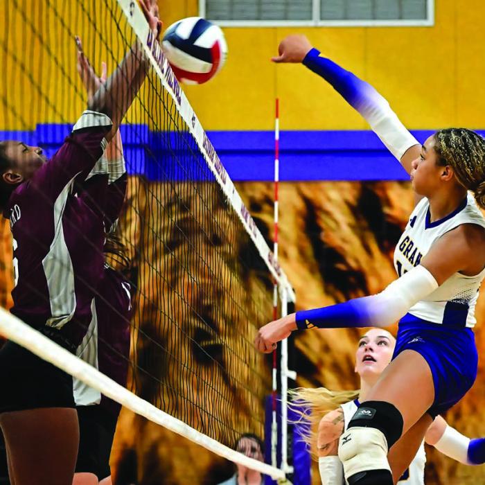 Brion Williams, right, battles at the net Tuesday night in La Grange’s sweep over East Bernard. Photo by Stephanie Steinhauser