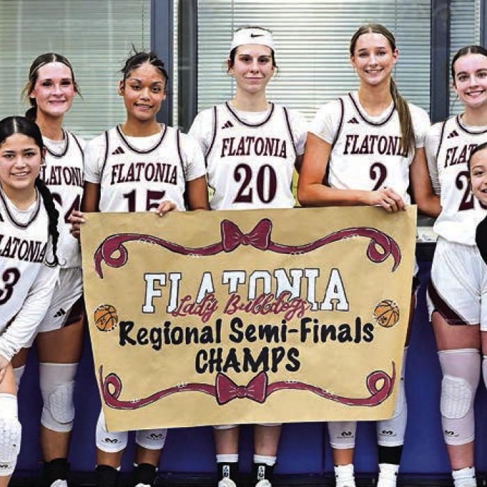 The Flatonia girls basketball team celebrates their win Monday in Seguin.