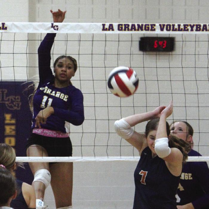 A Caldwell player retreats from a powerful hit by La Grange’s Brion Williams in Tuesday’s match. Photo by Jeff Wick