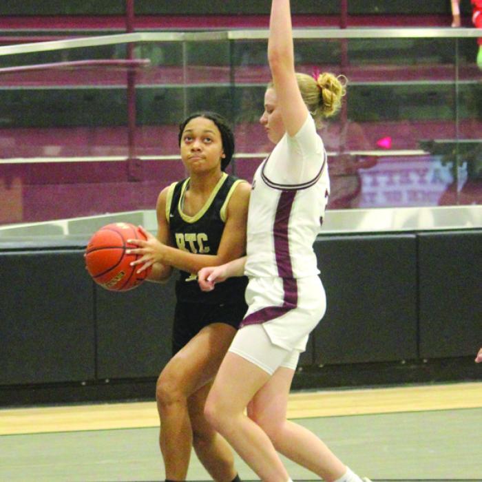 Above, Fayetteville’s Devynn Moeckel drives to the basket for two points in Tuesday’s game. Right: Round Top-Carmine’s Halle Phoenix prepares to shoot against the defense of Fayetteville’s Scotti Beseda. Photos by Jeff Wick