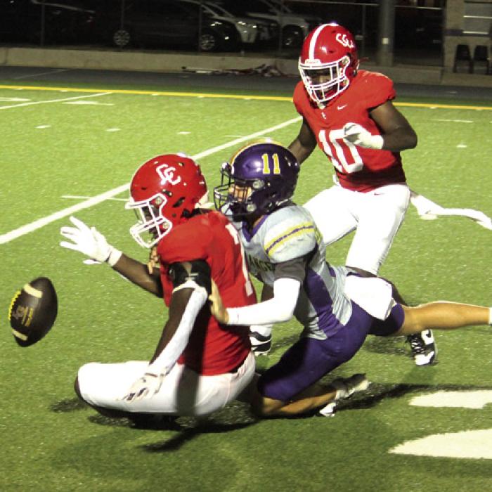 La Grange’s Eli Gillum and Columbus Sean Sutton try to get a handle on this loose football after the Cardinals blocked a punt Friday. Photo by Jeff Wick