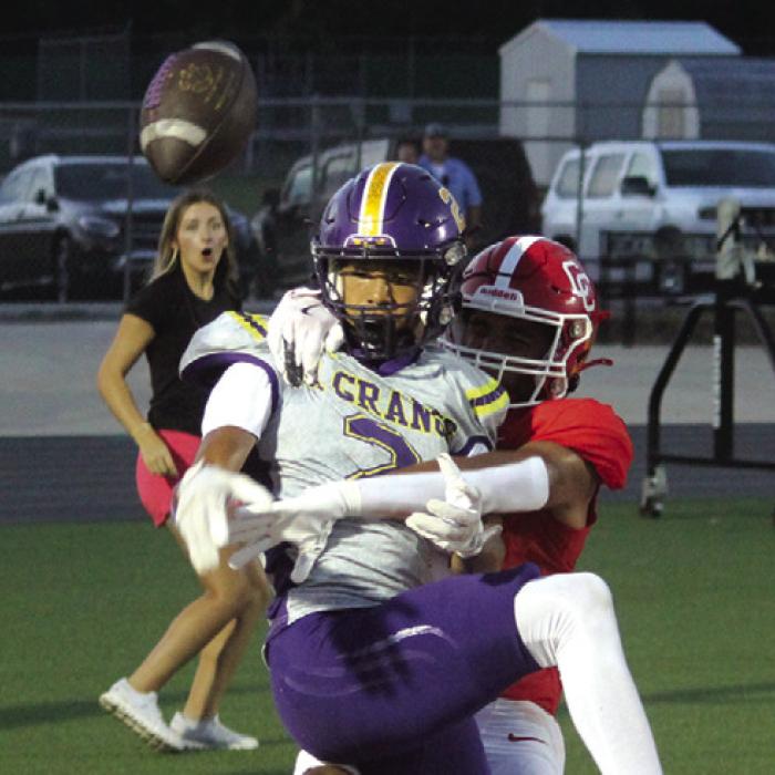 La Grange’s Dwodney Thompson tries to get free from a Columbus defensive back to grab this tipped pass Friday. Photo by Jeff Wick