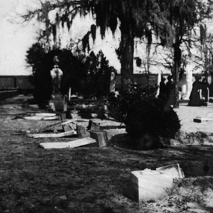 February 1908 photograph showing the broken tombstones along North College Street after vandalism in the old La Grange City Cemetery done by a drunken and disgruntled railroad worker. Train cars and onlookers can be seen in the background. Some of this damage is still evident today. Photo courtesy of the Fayette Heritage Museum and Archives