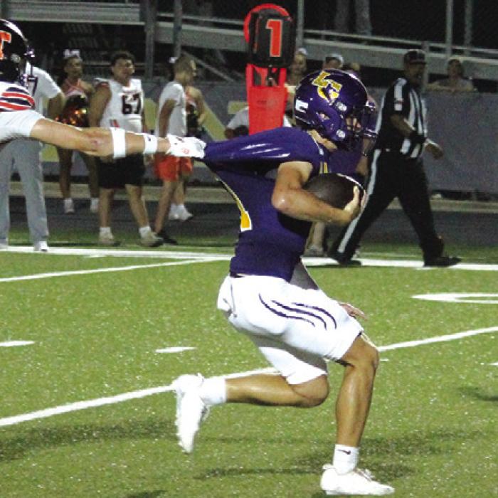 Smithville’s Bodie Goertz tries desperately to hold onto La Grange quarterback Eli Gillum Friday. Photo by Jeff Wick
