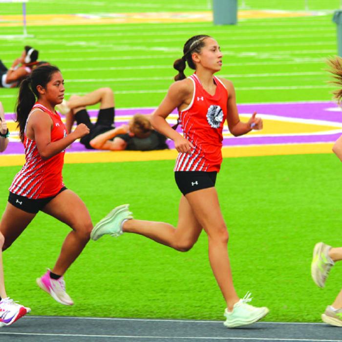 La Grange’s Lilian Carey leads the pack in the early stages of the varsity 3200 meters Thursday. She was second with a time of 12:42.81 Photo by Jeff Wick