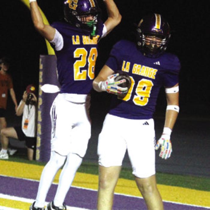 Ayden Gunter, left, and Travis Hill, right, celebrate Hill’s fourth quarter touchdown.