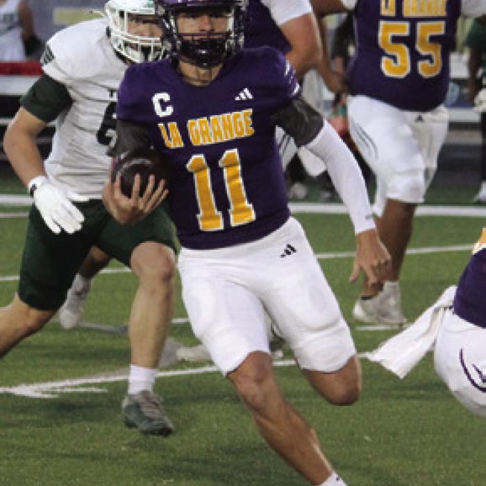 La Grange quarterback Eli Gillum picks his way through the Taylor defense Friday. Photos by Jeff Wick