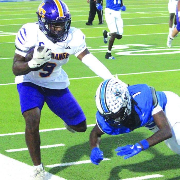 La Grange’s Dillan Johnson stiff-arms would-be Navasota tackler Da’Quan Pratt Friday. Photo by Jeff Wick