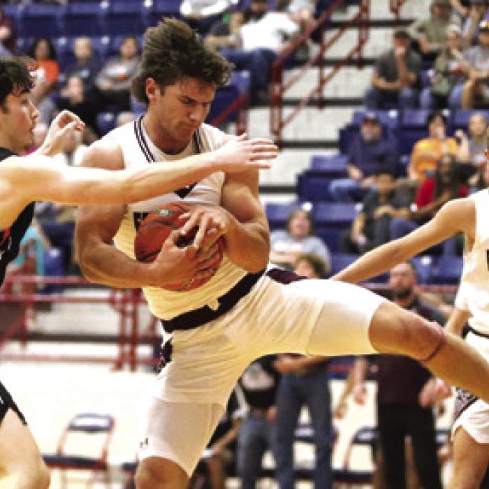 Fayetteville’s Jack Schley secures the rebound in front of Slade Tarrant of Wells in the fourth quarter.