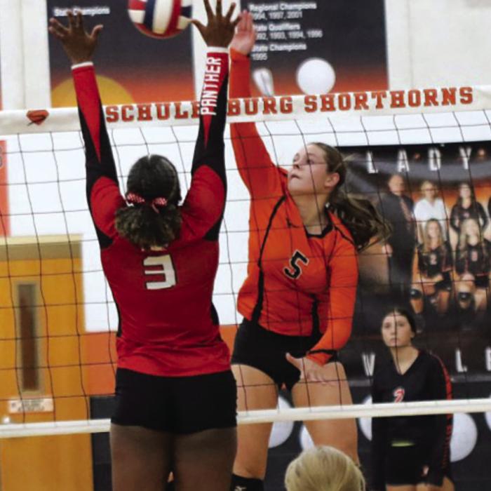 Schulenburg’s Haylee Vacek spikes the ball in Friday’s match against Burton. Photo by Audrey Kristynik