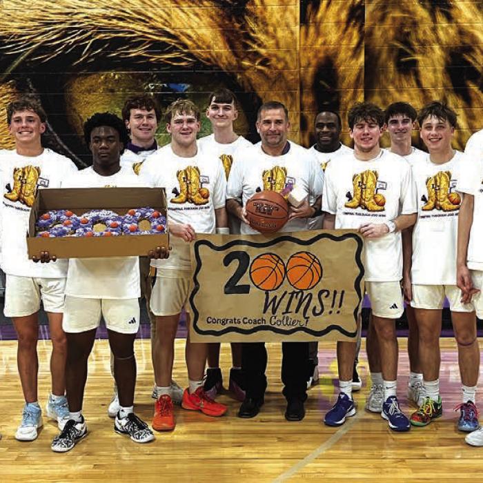 La Grange head boys basketball coach Trent Collier, center, holding the basketball, is shown here after Tuesday’s career victory #200 victory, celebrating with his varsity team, assistant coaches and family. Photo by Jeff Wick