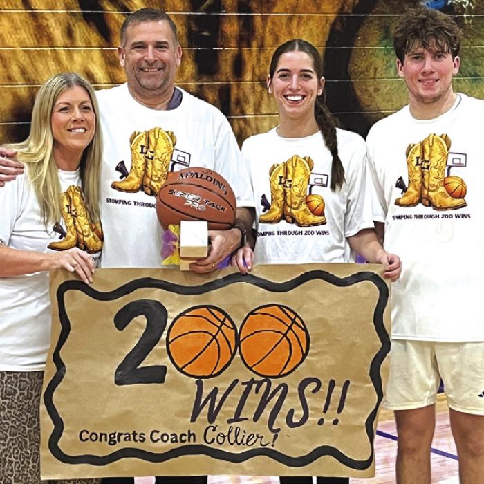 After Tuesday’s milestone 200th career win as a head coach, La Grange’s Trent Collier, second from left, poses with his wife, Kristy, daughter Macie, a junior on the Lady Leps basketball team, and Cole, right, a senior on the Leps basketball team. Photo by Jeff Wick