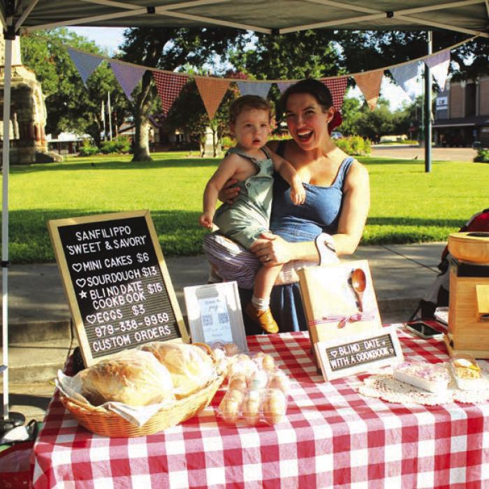 Kelly Sanfilippo of La Grange, holding her son Lucas, was selling sourdough bread, mini cakes and eggs.
