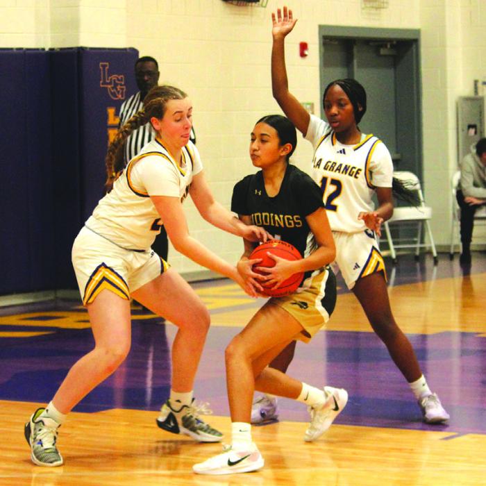 La Grange’s Hannah Gross, left, and Kaylee Holmes, right, double team this Giddings player during district basketball action Friday. Photo by Jeff Wick