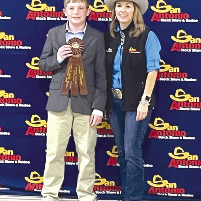 Fayette County 4-H Intermediate Team, Kaden Raabe who placed 9th high point, pictured with the SALE Representative.