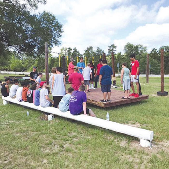 Campers at Camp Lost Pines in Warda enjoying the new low ropes course at the camp.