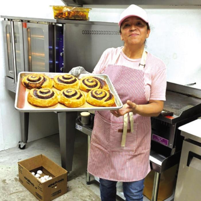 Rosa at Westside Shamrock serving up cinnamon rolls