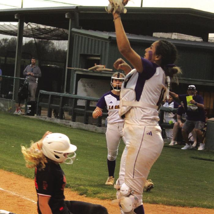 Addison Otto scores the winning run Tuesday as she beats the throw to catcher Melissa Gonzales.