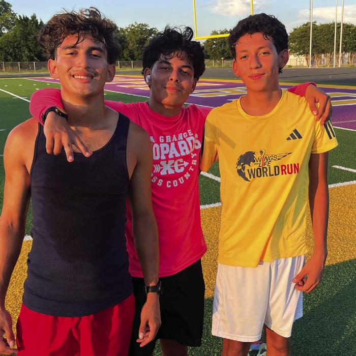 Left to right: Abbot Acosta, Dilan Barron and Jacob Estrada pose after distance practice with the Optimist Summer Track program Monday at Leopard Stadium. Photo by Jeff Wick