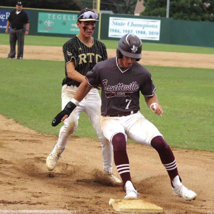 Fayetteville’s Jack Schley was safe as he won this footrace with RTC’s William Neese to third base during Game 2 of Thursday’s regional final.