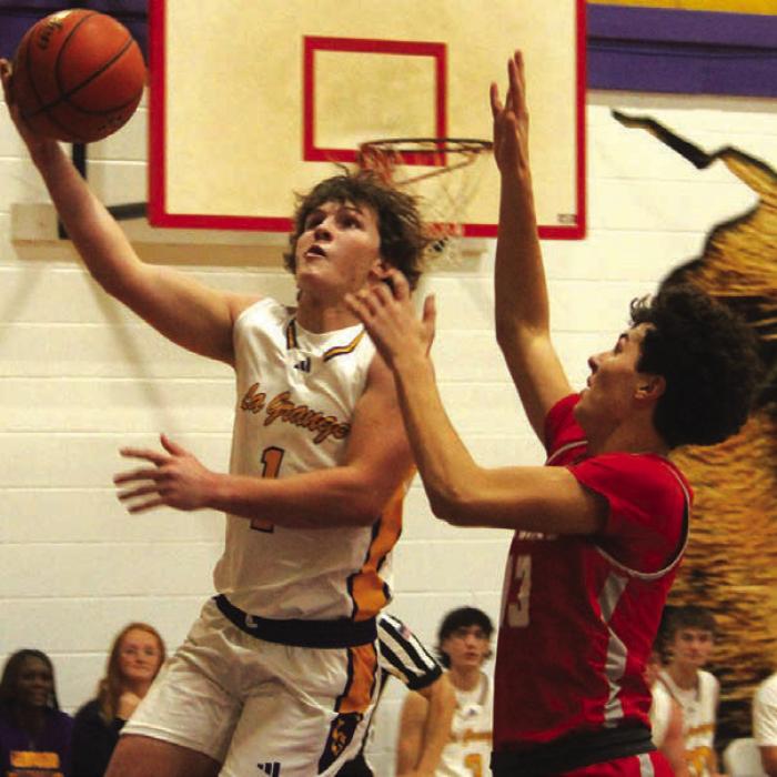 La Grange’s Clayton Cooper drives to the basket Friday. He scored nine points and had a teamhigh 13 rebounds Friday. Photo by Jeff Wick