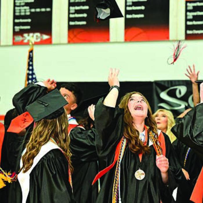 Schulenburg was among the last county schools to hold its graduation ceremonies when it did so Friday at their gym. Above, the grads (including Salutatorian Riley Zapalac, center and valedictorian Blake Helms, right) toss their hats with their fellow grads at the conclusion of the ceremony. Photo by Stephanie Steinhauser