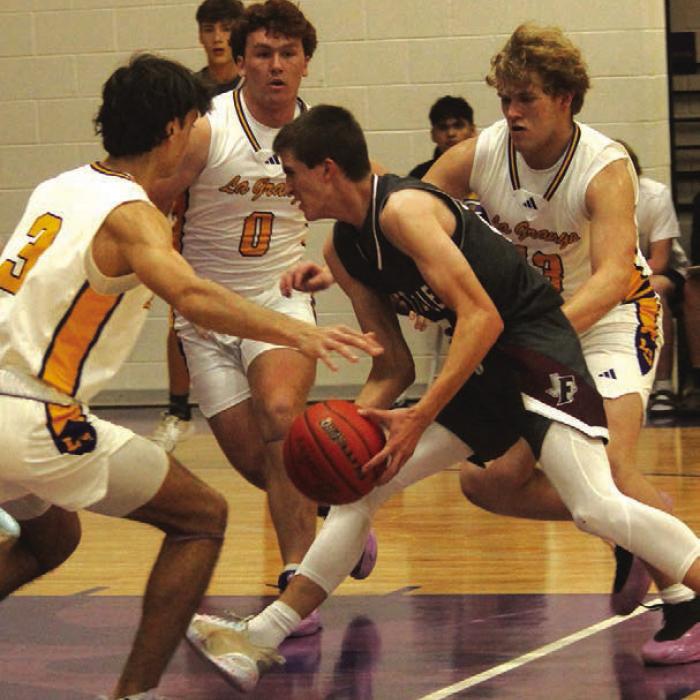 As Fayetteville’s Easton Jaeger drives to the basket Tuesday as La Grange’s Tre Supak, Oliver Gunn and Conner Brooks converge to try to stop him. Photo by Jeff Wick