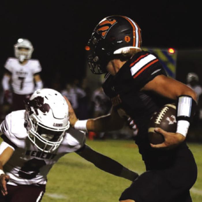 Schulenburg quarterback Aaron Janecek stiff-arms a would-be Kenedy tackler Friday. Photo by Audrey Kristynik