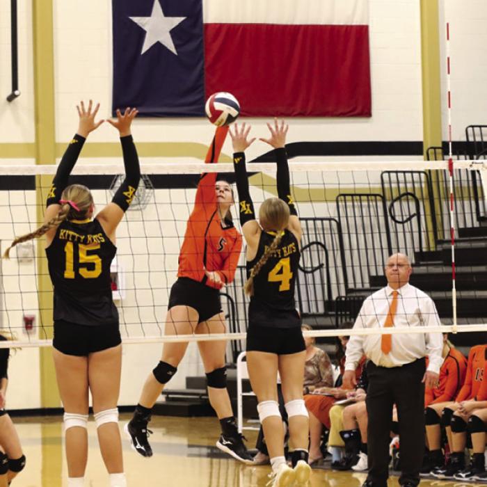 Schulenburg’s Haylee Vacek spikes a ball as head coach Donald Zapalac looks on Thursday. Photo by Audrey Kristynik