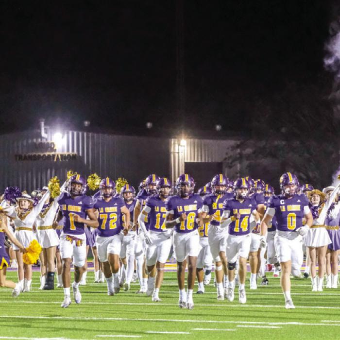 The members of the La Grange football team run onto the field at the start of Friday’s game. Photo by Andy Behlen