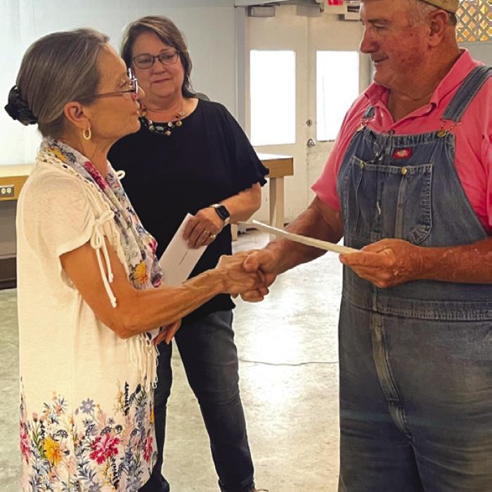 Cedar Creek Schuetzen Verein received donations from the Carmine Chamber of Commerce and the Carmine Lions Club for the purchase of new chairs for the Carmine Hall. Marie Loewe, left, Secretary/Treasurer for the Lions Club presented $2,020 and Marlene Waak, center, President of the Chamber presented $2,000 to Stuart Markwardt, right, President of the Carmine Hall at their May meeting.
