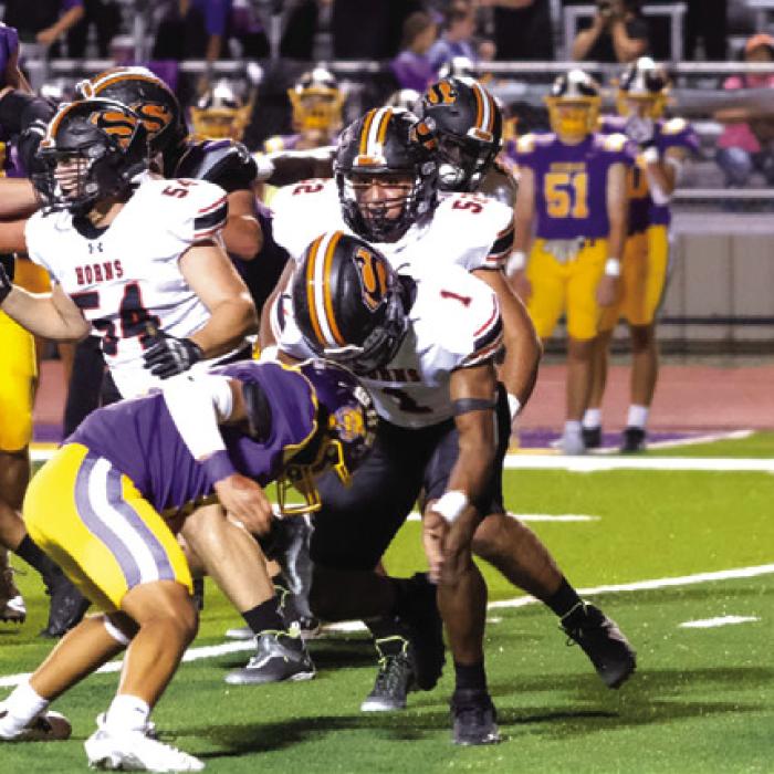 Schulenburg quarterback Aaron Janecek tries to get upfield with the ball Friday. Photo by Andy Behlen