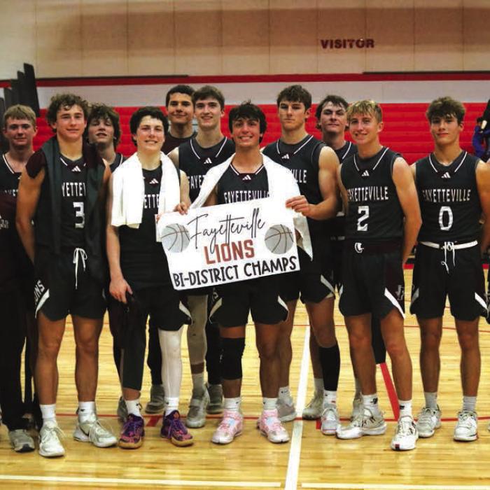 The members of the Fayetteville basketball team pose after Monday’s playoff victory.