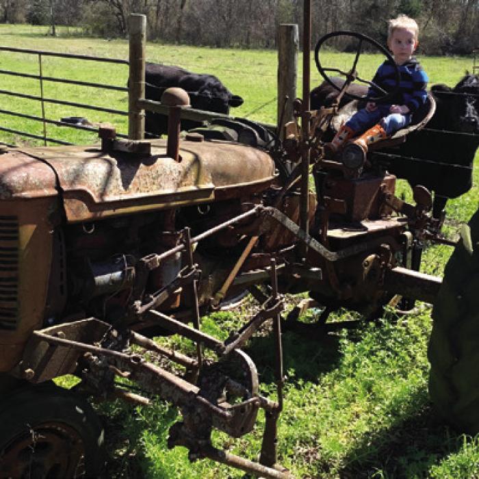 Henry Blezinger on his grandfather’s old Farmall C.
