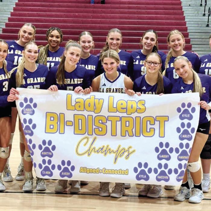 The members of the La Grange volleyball team celebrate after Thursday’s opening round playoff victory over Katy Freeman.