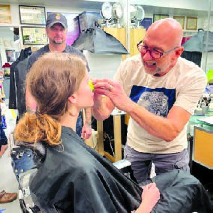 Matthew W. Bungle applying makeup to theater student Hannah Barley.