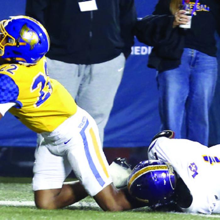 Trey Broussard pulls down La Vega’s Benjamin Thompson along the sideline for a touchdownsaving tackle in the second quarter. However, the Pirates scored a few plays later. Photo by Ken Sury/Special to the Record