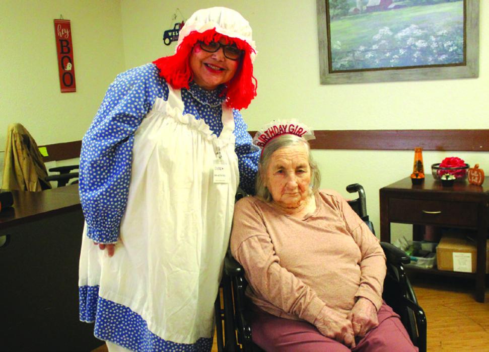 Flora Jahnz, seated, celebrated her 102nd birthday on Halloween, Oct. 31, at Care Inn in La Grange. She is shown here getting ready for the day’s festivities, which included handing out candy to kids that night. Photos by Jeff Wick