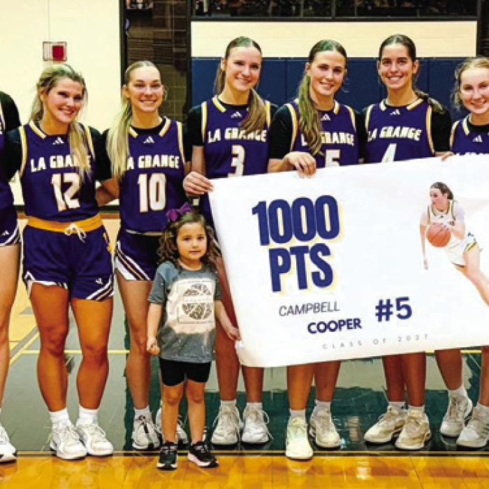 La Grange junior Campbell Cooper reached the 1,000-point mark for her high school career in Tuesday’s win at Cedar Creek. She’s shown here, center, celebrating with her teammates.