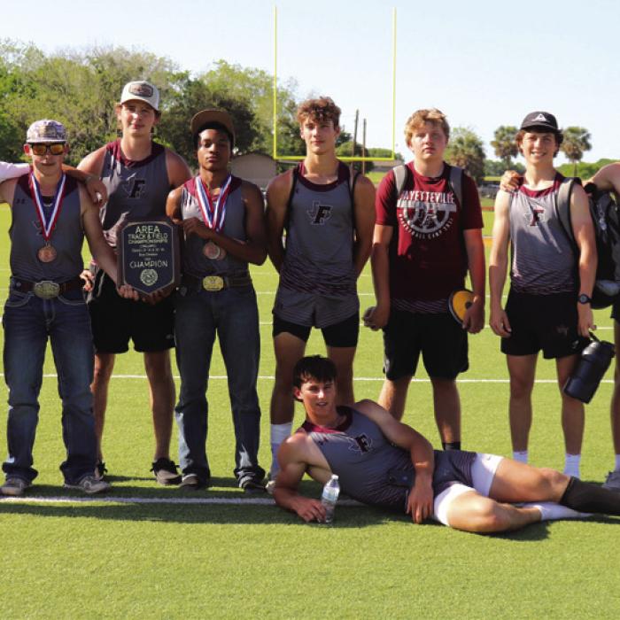The Fayetteville boys track athletes pose with their Area championship plaque after Thursday’s meet in Runge.