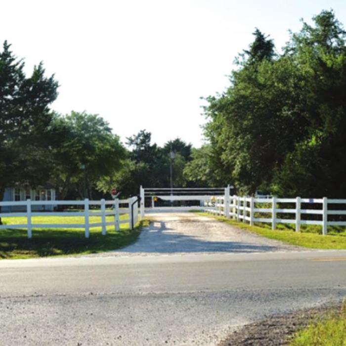 A board fence surrounds Whispering Hills Achievement Center near Flatonia. An investigation into the residential facility for special needs youth revealed allegation of abuse and neglect by staff. Photo by Andy Behlen