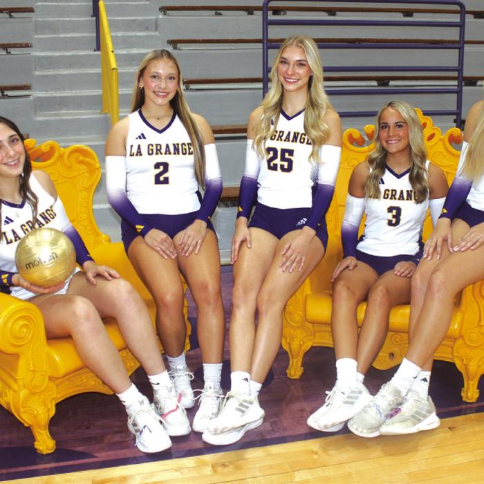 The seniors members of the La Grange volleyball team this season are, from left to right: Faith Greenwood, Kyla Colon, Kylie Trlicek, Clara Bundick and Carley Ulrich. They are seated in a pair of iconic yellow chairs that local shoppers may recognize from the store Bundick’s mother owns – Julie B, on the courthouse square. Photo by Jeff Wick