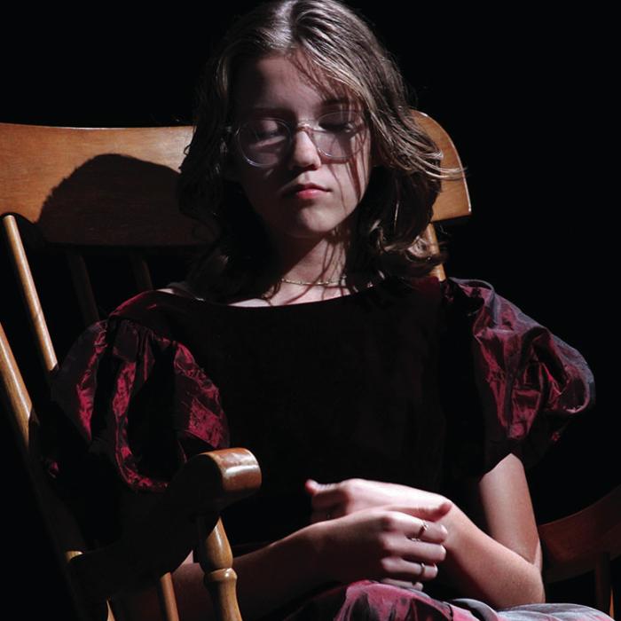 Emma Koeth, who plays Wendy’s mother, sits on a rocking chair as the directors discuss what to do next in rehearsal.