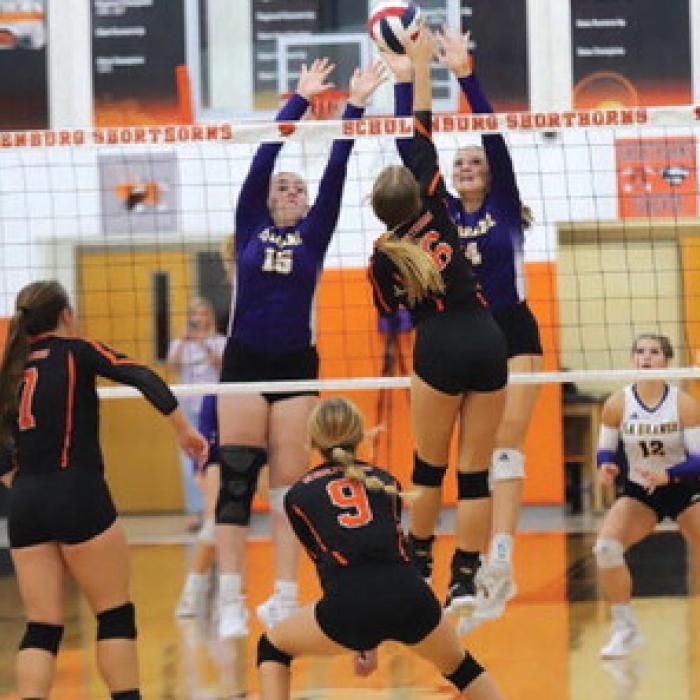 La Grange's Hannah Gross and Avery Grib n try to block the spike of Schulenburg's Clara Magliolo in Friday's match. Photo by Audrey Kristynik