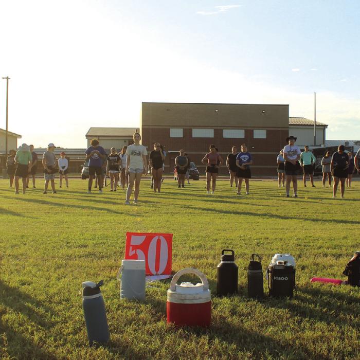 Water bottles dot the area around the 50-yard line on the band’s marching practice field as the sun begins to set during the band’s practice Friday evening. Photos by Jeff Wick
